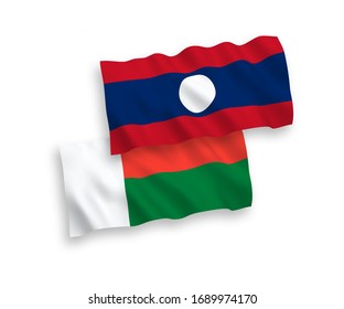 National vector fabric wave flags of Madagascar and Laos isolated on white background. 1 to 2 proportion.