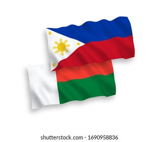 National vector fabric wave flags of Madagascar and Philippines isolated on white background. 1 to 2 proportion.