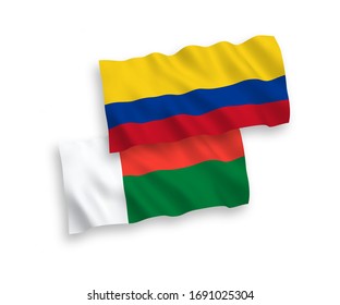 National vector fabric wave flags of Madagascar and Colombia isolated on white background. 1 to 2 proportion.