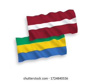 National vector fabric wave flags of Latvia and Gabon isolated on white background. 1 to 2 proportion.