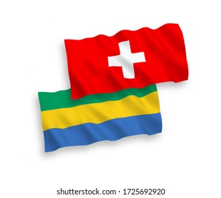 National vector fabric wave flags of Gabon and Switzerland isolated on white background. 1 to 2 proportion.