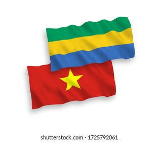 National vector fabric wave flags of Gabon and Vietnam isolated on white background. 1 to 2 proportion.