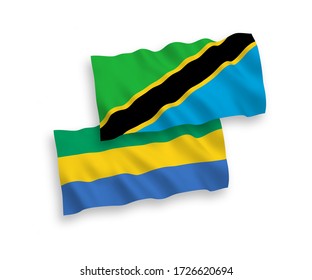 National vector fabric wave flags of Gabon and Tanzania isolated on white background. 1 to 2 proportion.