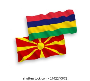 National vector fabric wave flags of Mauritius and North Macedonia isolated on white background. 1 to 2 proportion.