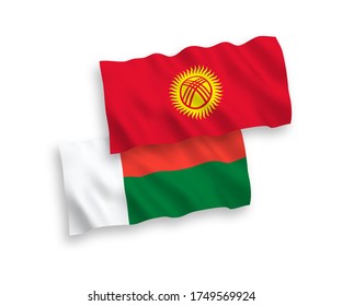 National vector fabric wave flags of Kyrgyzstan and Madagascar isolated on white background. 1 to 2 proportion.