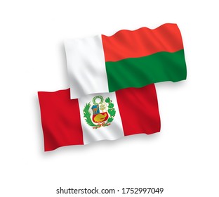 National vector fabric wave flags of Peru and Madagascar isolated on white background. 1 to 2 proportion.