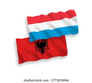 National vector fabric wave flags of Albania and Luxembourg isolated on white background. 1 to 2 proportion.