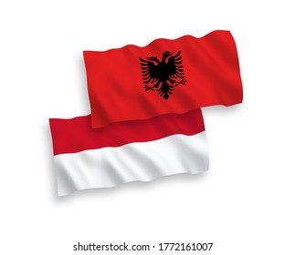 National vector fabric wave flags of Indonesia and Albania isolated on white background. 1 to 2 proportion.