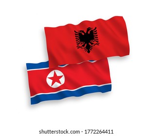 Banderas de olas de tela vectorial nacional de Corea del Norte y Albania aisladas en fondo blanco. de 1 a 2.