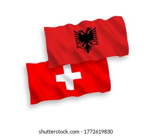 National vector fabric wave flags of Albania and Switzerland isolated on white background. 1 to 2 proportion.