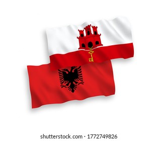 National vector fabric wave flags of Albania and Gibraltar isolated on white background. 1 to 2 proportion.