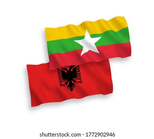 National vector fabric wave flags of Albania and Myanmar isolated on white background. 1 to 2 proportion.