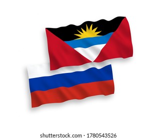 National vector fabric wave flags of Antigua and Barbuda and Russia isolated on white background. 1 to 2 proportion.