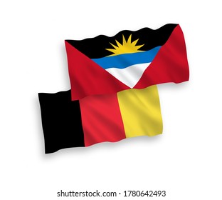 National vector fabric wave flags of Antigua and Barbuda and Belgium isolated on white background. 1 to 2 proportion.