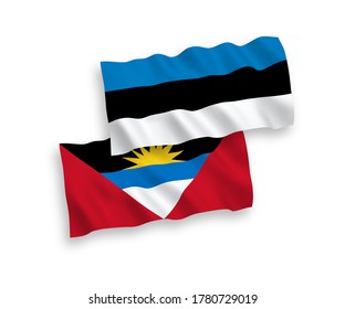 National vector fabric wave flags of Estonia and Antigua and Barbuda isolated on white background. 1 to 2 proportion.