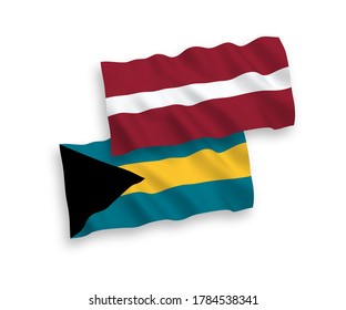 National vector fabric wave flags of Latvia and Commonwealth of The Bahamas isolated on white background. 1 to 2 proportion.