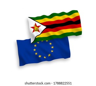 National vector fabric wave flags of European Union and Zimbabwe isolated on white background. 1 to 2 proportion.