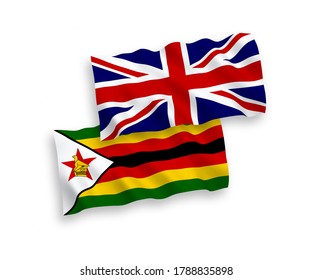 National vector fabric wave flags of Great Britain and Zimbabwe isolated on white background. 1 to 2 proportion.