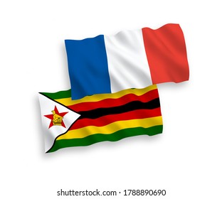 National vector fabric wave flags of France and Zimbabwe isolated on white background. 1 to 2 proportion.