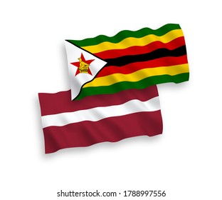 National vector fabric wave flags of Latvia and Zimbabwe isolated on white background. 1 to 2 proportion.