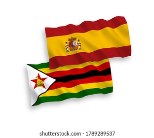 National vector fabric wave flags of Zimbabwe and Spain isolated on white background. 1 to 2 proportion.