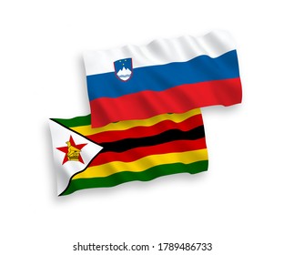National vector fabric wave flags of Slovenia and Zimbabwe isolated on white background. 1 to 2 proportion.