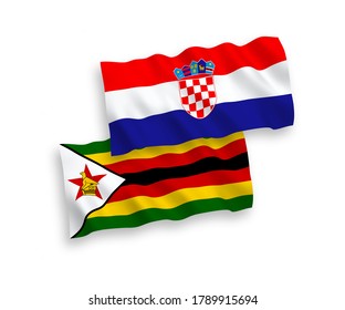 Banderas de olas de tela vectorial nacional de Zimbabue y Croacia aisladas en fondo blanco. de 1 a 2.