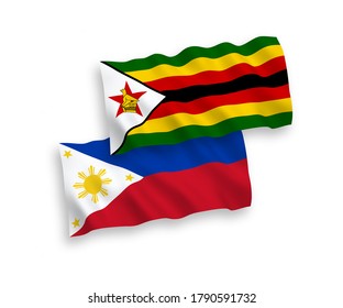 National vector fabric wave flags of Zimbabwe and Philippines isolated on white background. 1 to 2 proportion.