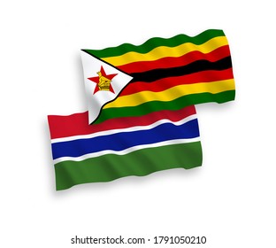 National vector fabric wave flags of Zimbabwe and Republic of Gambia isolated on white background. 1 to 2 proportion.