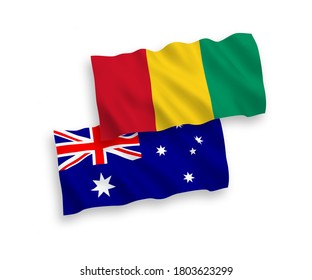 National vector fabric wave flags of Australia and Guinea isolated on white background. 1 to 2 proportion.