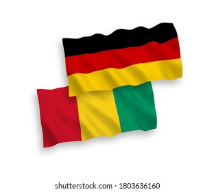 National vector fabric wave flags of Germany and Guinea isolated on white background. 1 to 2 proportion.