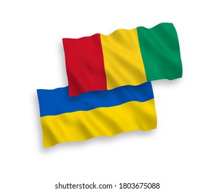 National vector fabric wave flags of Guinea and Ukraine isolated on white background. 1 to 2 proportion.