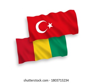 National vector fabric wave flags of Turkey and Guinea isolated on white background. 1 to 2 proportion.