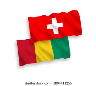 National vector fabric wave flags of Guinea and Switzerland isolated on white background. 1 to 2 proportion.