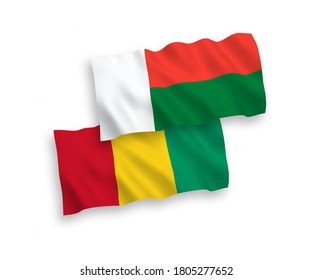 National vector fabric wave flags of Guinea and Madagascar isolated on white background. 1 to 2 proportion.
