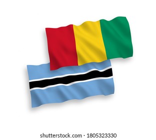 National vector fabric wave flags of Guinea and Botswana isolated on white background. 1 to 2 proportion.