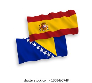 National vector fabric wave flags of Bosnia and Herzegovina and Spain isolated on white background. 1 to 2 proportion.