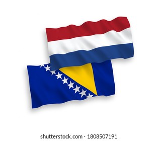 National vector fabric wave flags of Bosnia and Herzegovina and Netherlands isolated on white background. 1 to 2 proportion.