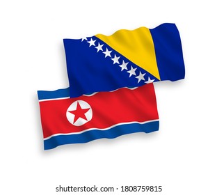 National vector fabric wave flags of North Korea and Bosnia and Herzegovina isolated on white background. 1 to 2 proportion.
