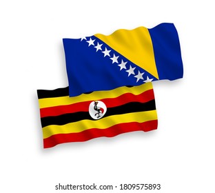 National vector fabric wave flags of Bosnia and Herzegovina and Uganda isolated on white background. 1 to 2 proportion.