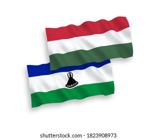 National vector fabric wave flags of Lesotho and Hungary isolated on white background. 1 to 2 proportion.