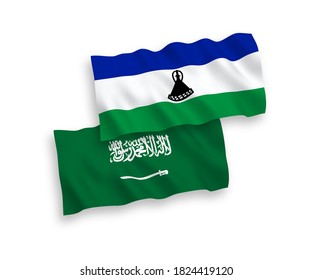 National vector fabric wave flags of Saudi Arabia and Lesotho isolated on white background. 1 to 2 proportion.