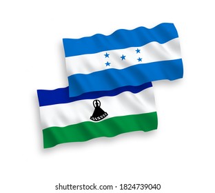 National vector fabric wave flags of Lesotho and Honduras isolated on white background. 1 to 2 proportion.