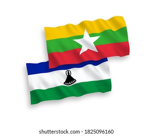 Banderas de ondulación de tela vectorial nacional de Lesotho y Myanmar aisladas en fondo blanco. de 1 a 2.