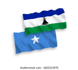 National vector fabric wave flags of Lesotho and Somalia isolated on white background. 1 to 2 proportion.