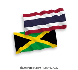 National vector fabric wave flags of Jamaica and Thailand isolated on white background. 1 to 2 proportion.