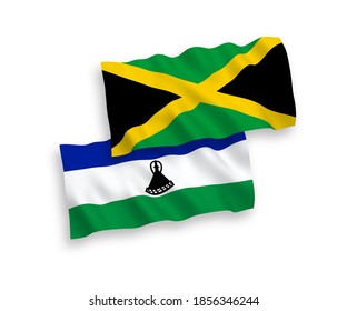 National vector fabric wave flags of Jamaica and Lesotho isolated on white background. 1 to 2 proportion.