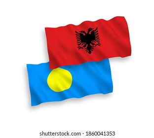 National vector fabric wave flags of Palau and Albania isolated on white background. 1 to 2 proportion.