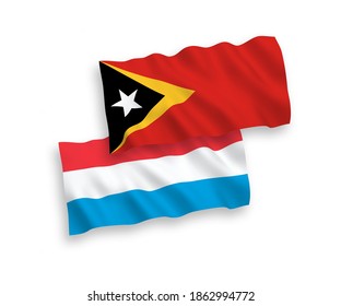 National vector fabric wave flags of East Timor and Luxembourg isolated on white background. 1 to 2 proportion.