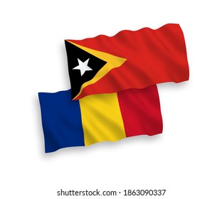 National vector fabric wave flags of Romania and East Timor isolated on white background. 1 to 2 proportion.